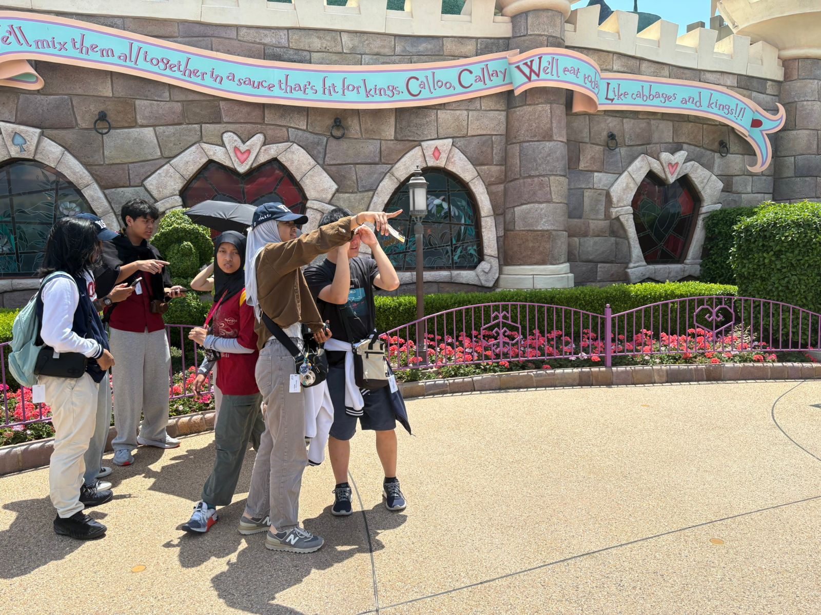 YIS students pointing toward the next attraction at Tokyo Disneyland