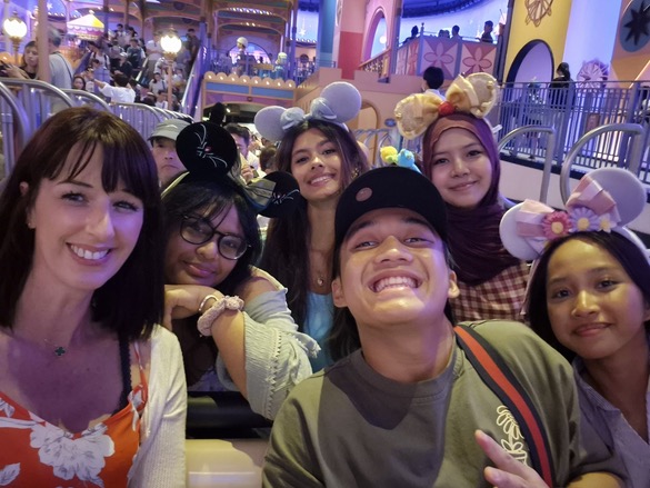 YIS travelers smiling together during a Tokyo Disneyland ride