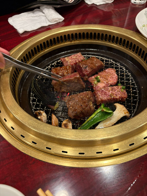 Meat grilling at a yakiniku table in Tokyo