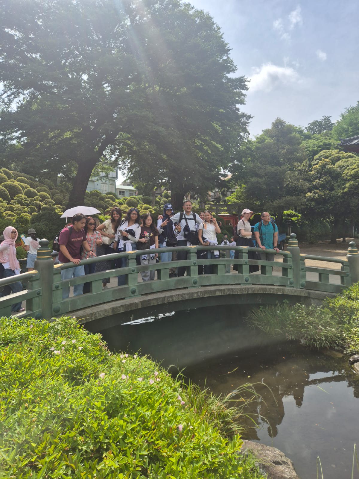 YIS travelers on a bridge in the Nezu Shrine garden