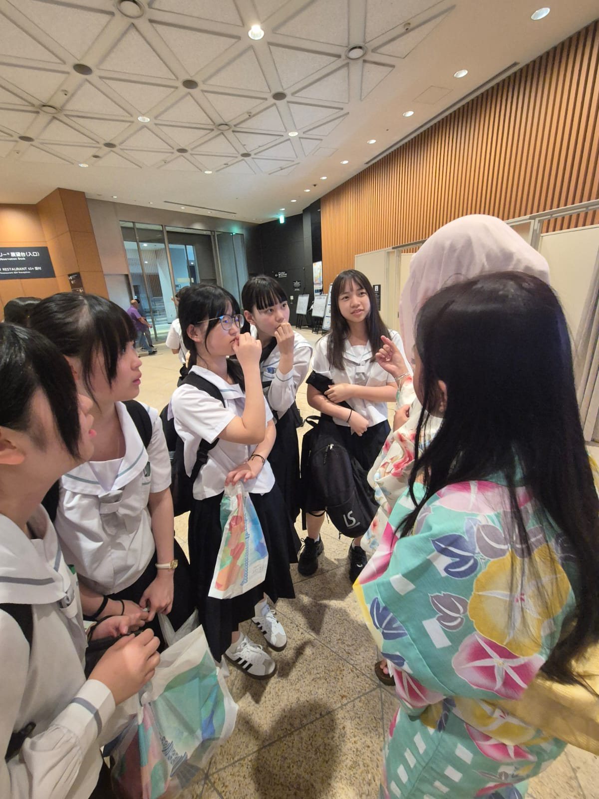 YIS student in kimono speaking with Japanese students