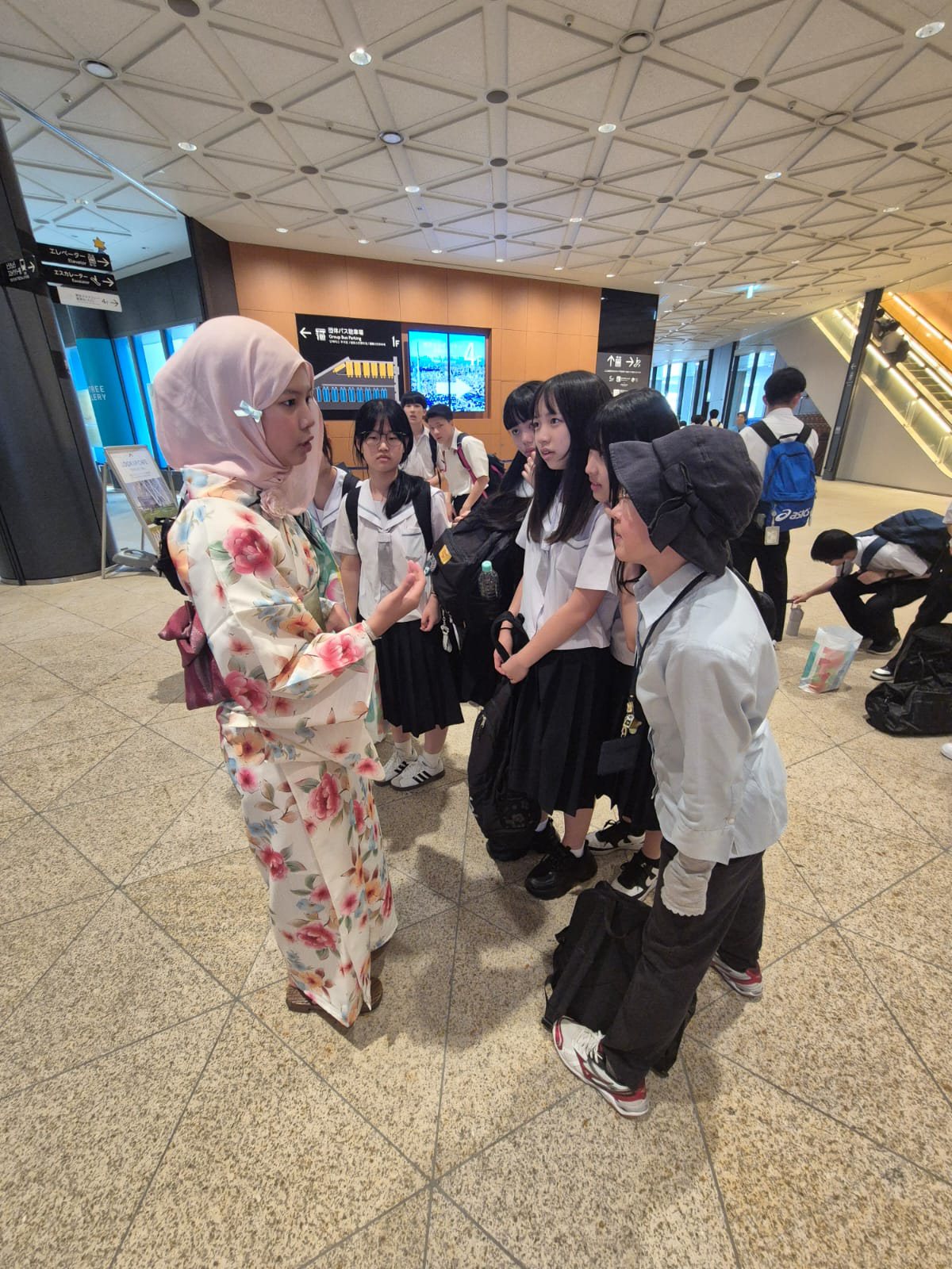 YIS student interacting with Japanese students at Tokyo Skytree