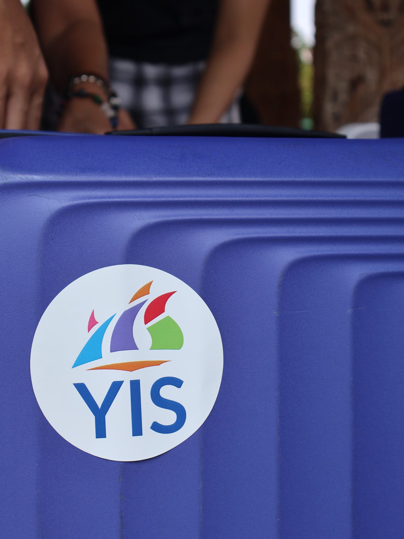 A YIS logo on luggage prepared for the journey
